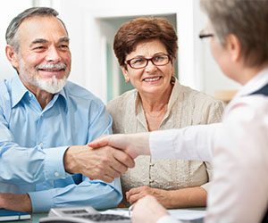 Older man and woman discussing home financing